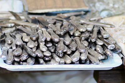 Close-up of stacked knives in tray on table