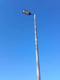 Low angle view of street light against clear blue sky