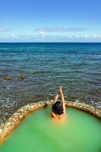 Rear view of man in swimming pool