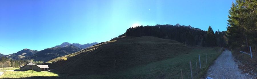 Scenic view of mountains against clear blue sky