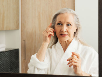 Young woman using mobile phone at home