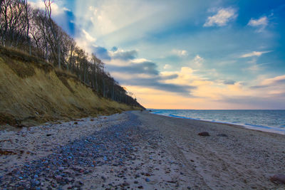 Scenic view of beach against sky during sunset