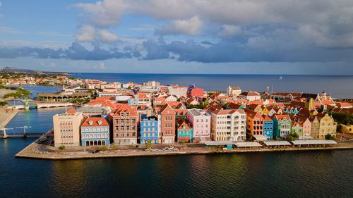 Townscape by sea against sky