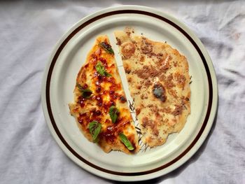 High angle view of pizza served on table