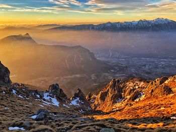 Scenic view of snowcapped mountains against sky during sunset