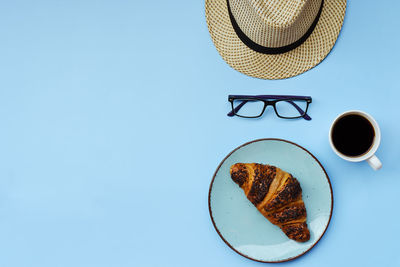 Directly above shot of breakfast served on table against blue background