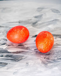 Close-up of orange on ice on table