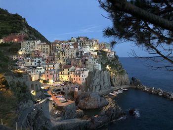 High angle view of townscape by sea against sky