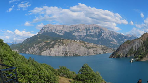 Scenic view of lake and mountains against sky