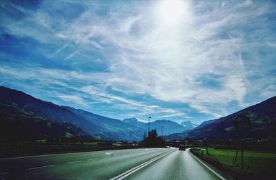 Road amidst mountains against sky