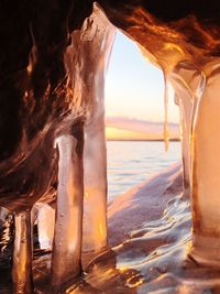 Close-up of sea against sky during sunset