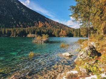 Scenic view of lake against blue sky in autumn