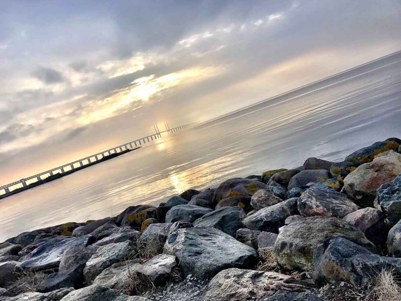 ROCKS AT BEACH AGAINST SKY DURING SUNSET