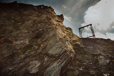 Low angle view of rock formation on land against sky