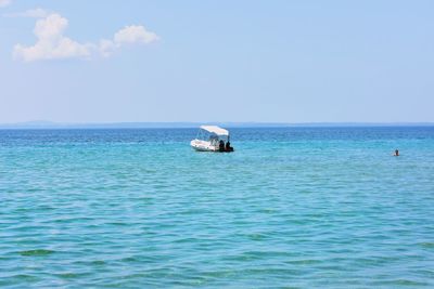 Sailboat in sea against sky