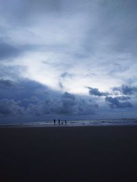 People on beach against sky