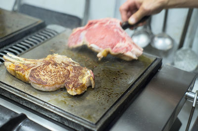 Close-up of man preparing food in kitchen