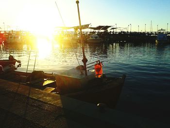 Boats in river at sunset