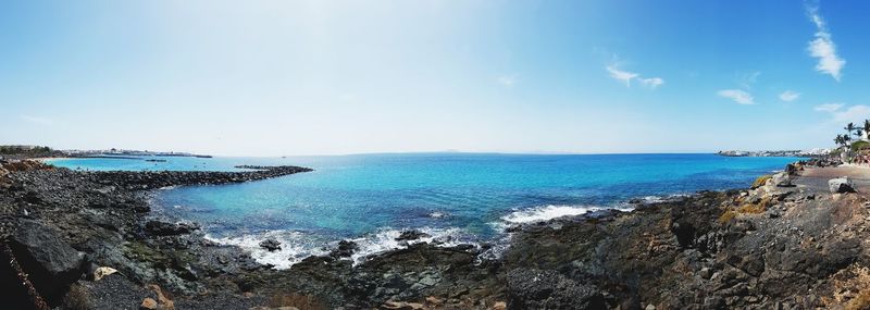 Scenic view of sea against blue sky