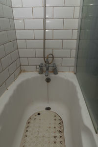 Low section of woman standing in bathroom