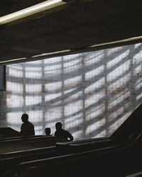 Rear view of silhouette people standing in building