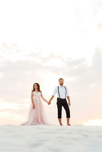 Full length of woman standing against sky