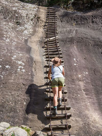 Rear view of woman on steps