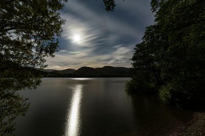 Scenic view of ullswater with the moon shining through the cloudy sky