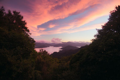 Scenic view of silhouette mountains against orange sky