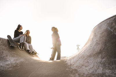 Teenage girls with skateboards in skatepark