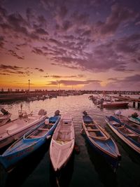 Boats moored at sunset