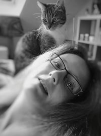 Portrait of cat wearing eyeglasses at home