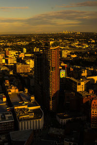 High angle view of buildings in city against sky during sunset