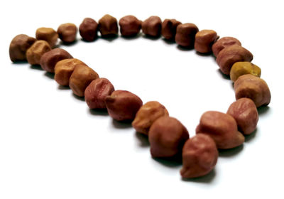 Close-up of coffee beans against white background