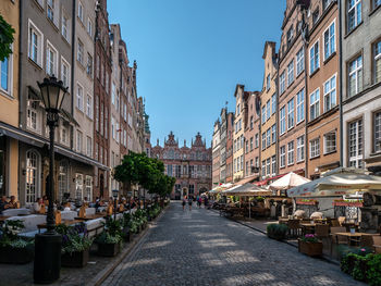 Street amidst buildings in city against clear sky