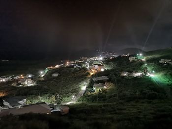 High angle view of illuminated buildings in city at night