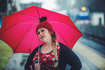 Portrait of woman with red umbrella