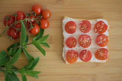 Healthy toast for breakfast with avocado, eggs, tomatoes, arugula etc