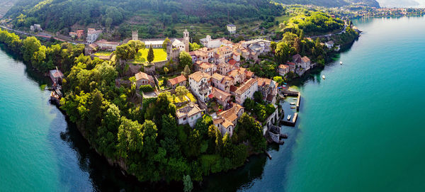 High angle view of trees and buildings by sea