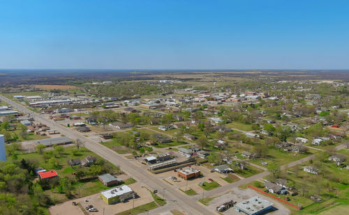 High angle view of city buildings against clear sky