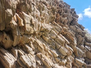 Low angle view of stack of rocks against sky