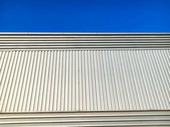 Low angle view of building against clear blue sky