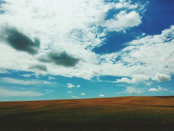 Scenic view of landscape against cloudy sky