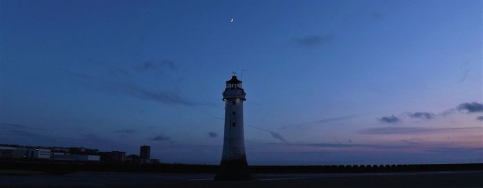 Low angle view of lighthouse against sky at dusk