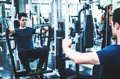 Young man exercising in gym