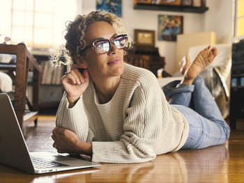 Young woman using laptop while sitting at home