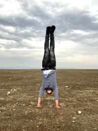 Man standing on field against sky