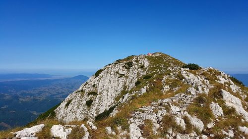 Scenic view of mountains against clear blue sky