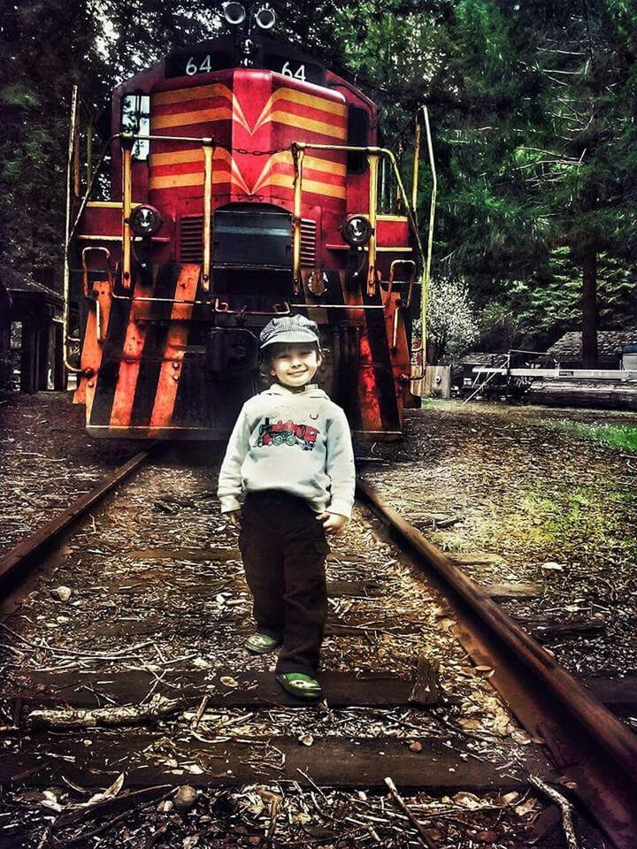 PORTRAIT OF MAN STANDING BY RAILROAD TRACK