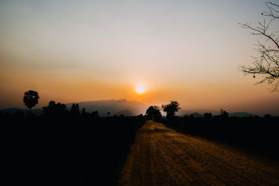 Scenic view of silhouette field against sky during sunset